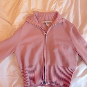 Cinched pink zip up hoodie with double zipper. One at top and one at the bottom